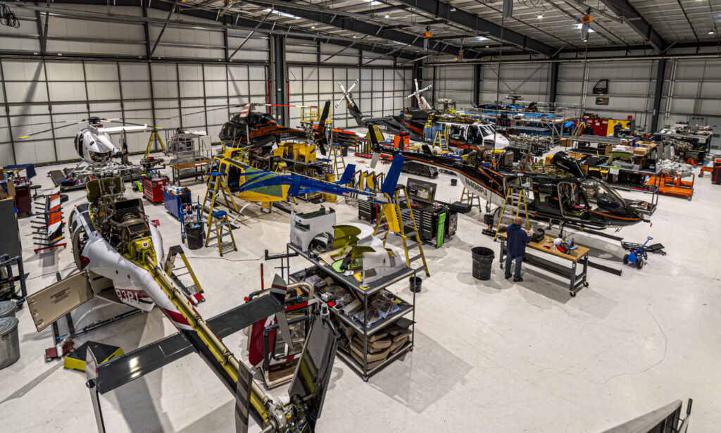 Maintenance technicians do repairs on multiple helicopters.